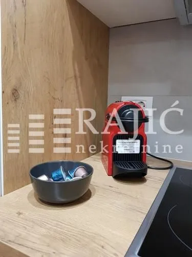 Kitchen detail showing a coffee machine and countertop.