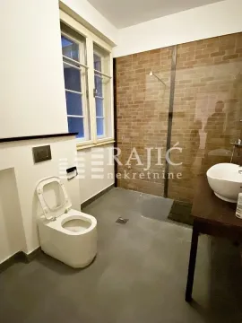 Modernly equipped bathroom with a walk-in shower and a window. - image 10