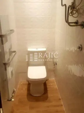 Small bathroom with toilet and ceramic tiles. - image 13
