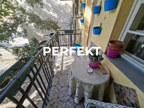 Manji namešten balkon sa stolom, stolicom i ukrasnim saksijama za cveće. - image 17