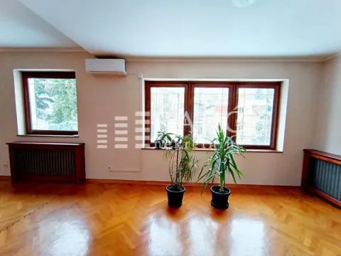 Spacious empty room with wooden flooring and large windows. - image 12