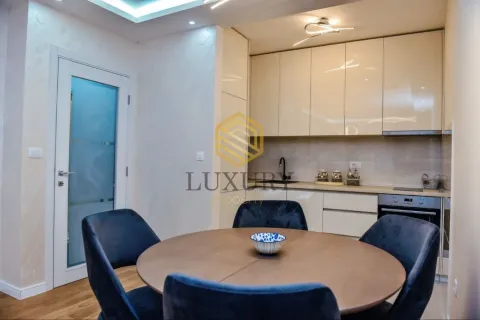 Modern kitchen with a dining table and chairs. - image 4
