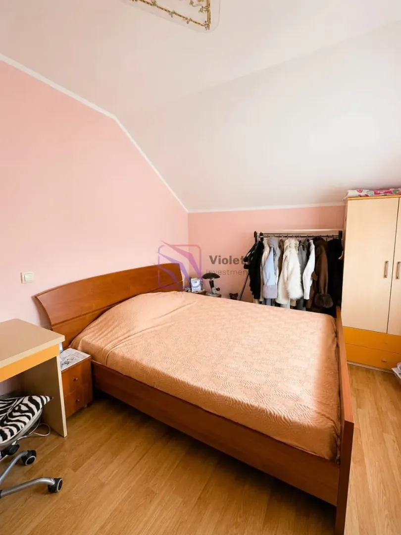 Bedroom with a double bed, wardrobe, and desk.