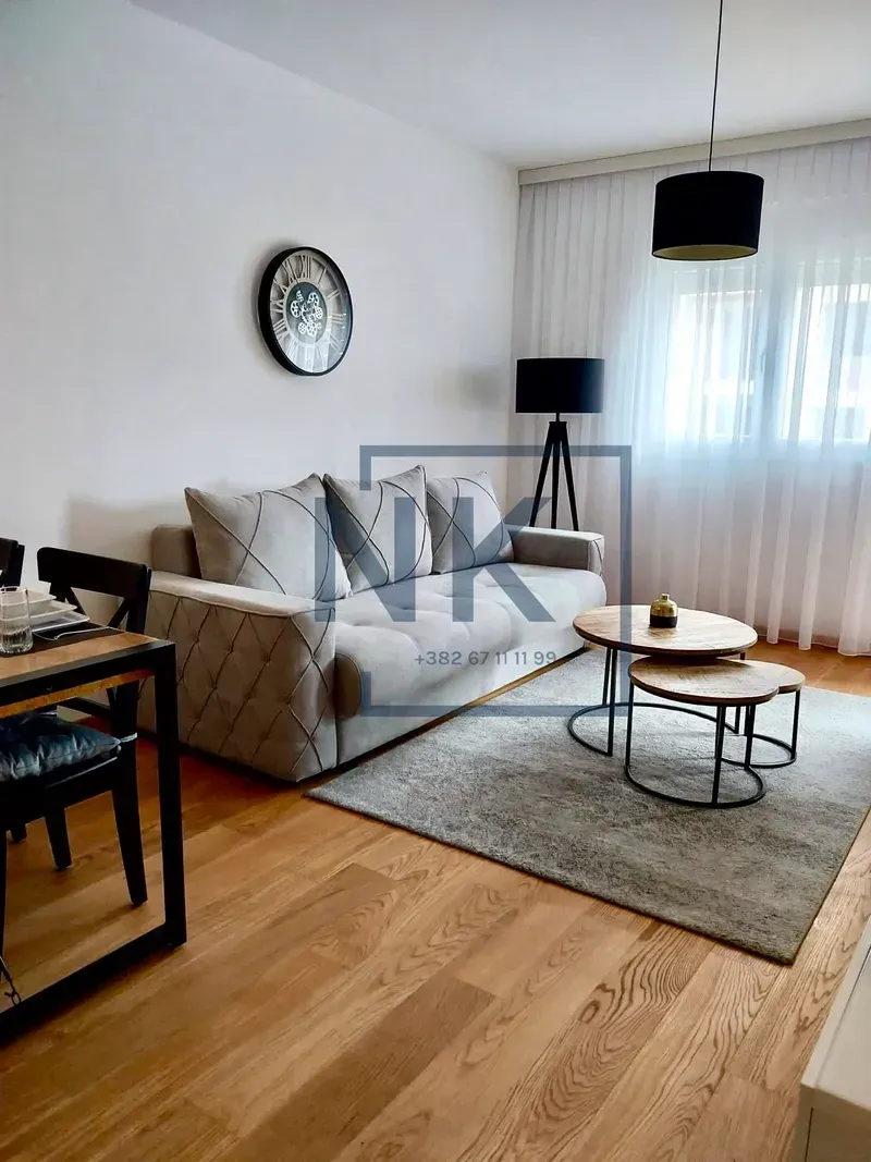 Living room with a sofa, coffee table, and dining table.