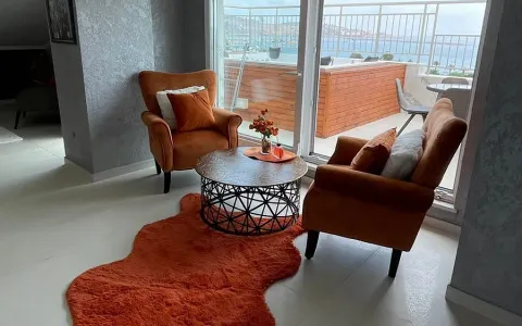 Living room with comfortable armchairs and access to a terrace with a sea view. - image 4