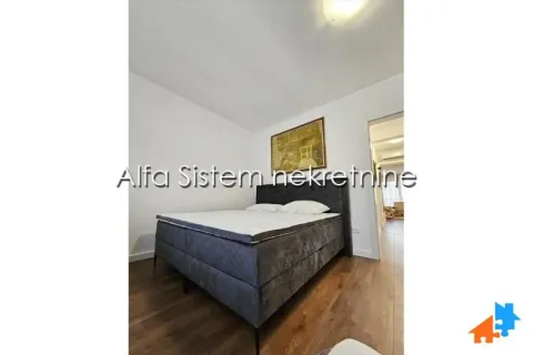 Bedroom with a double bed and wooden flooring. - image 13