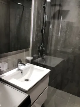 Modern bathroom with a sink and shower. - image 28