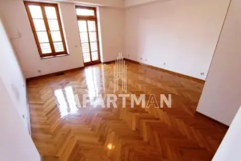 Empty room with wooden parquet flooring and two windows. - image 4