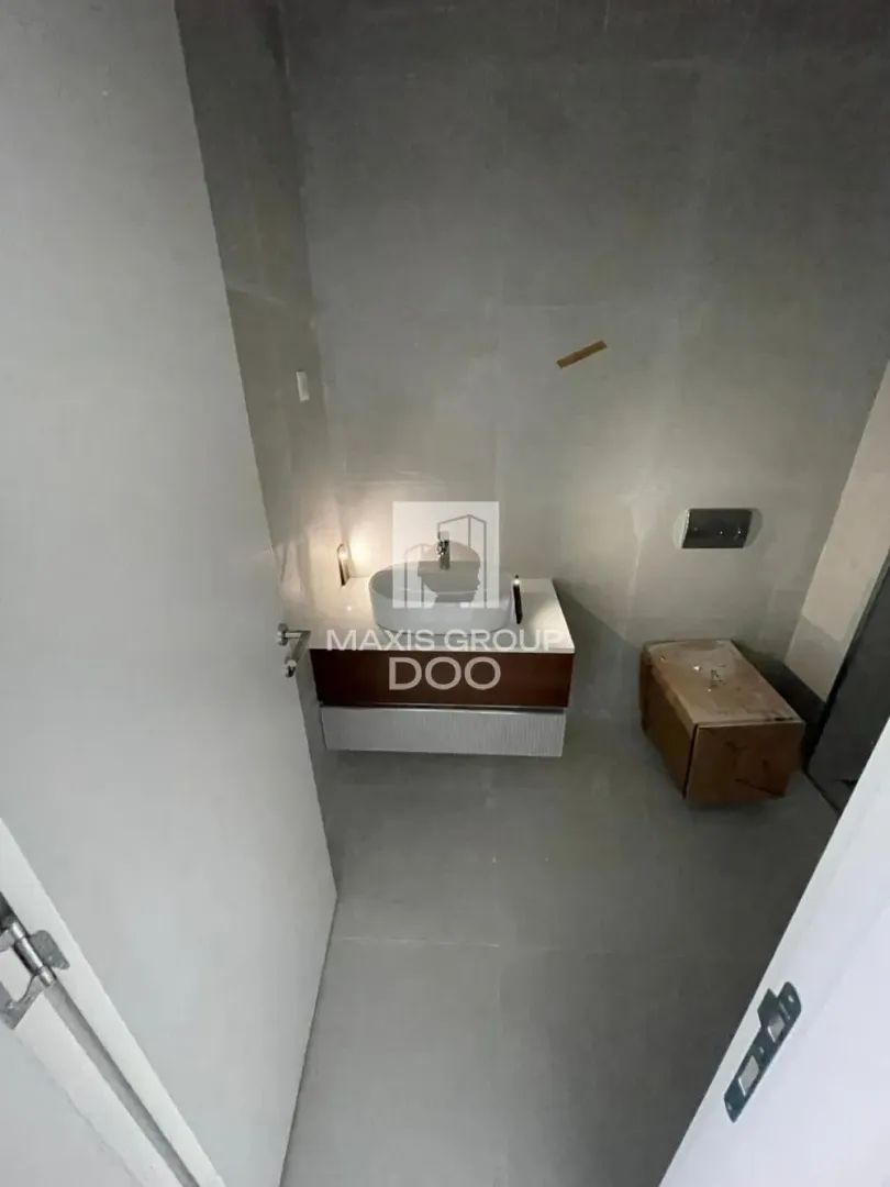 Small bathroom with a washbasin and gray tiles.