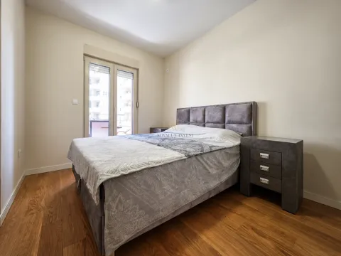 Bedroom with a double bed, nightstands, and balcony doors. - image 7