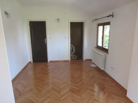 Empty room with parquet flooring and two doors. - image 3