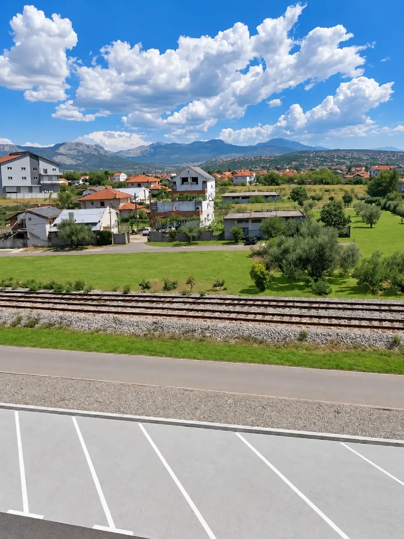 View from the property overlooking the surrounding neighborhood, railway tracks, and mountains in the distance.