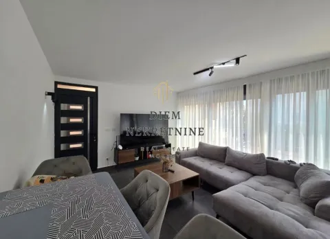 Spacious living room with a sofa set and dining table. - image 3