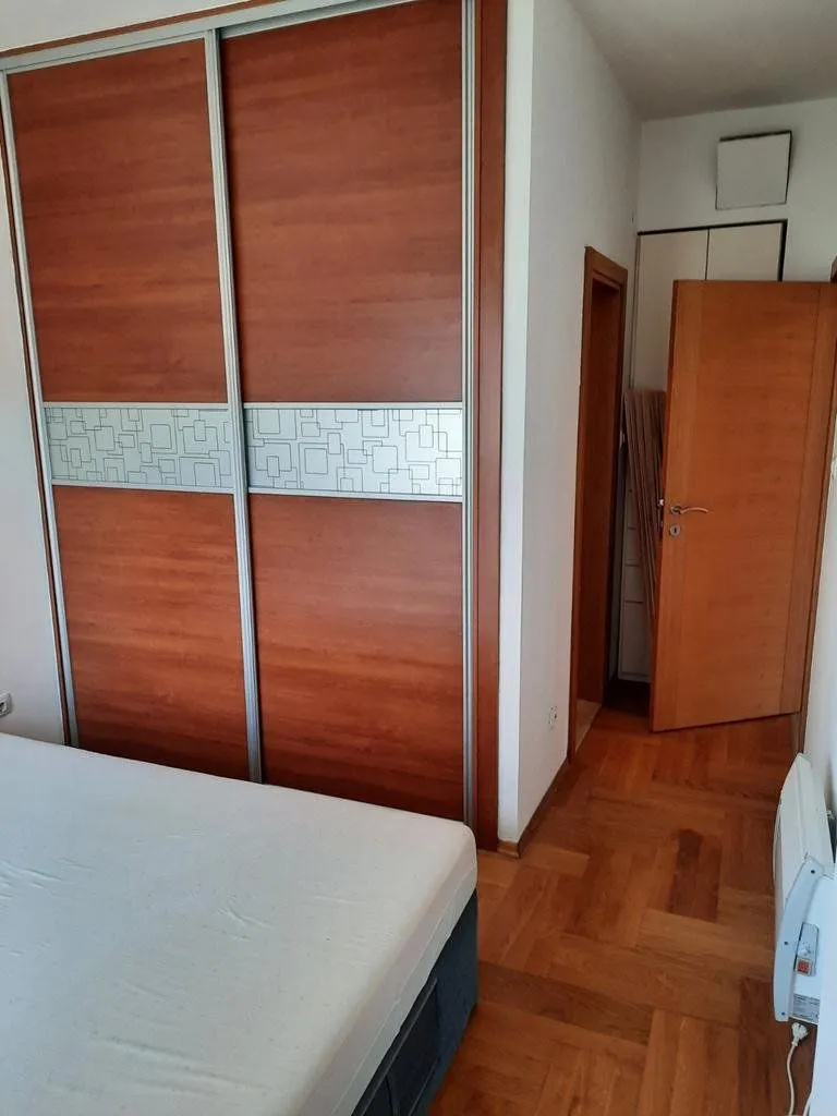 Bedroom with a large built-in wardrobe and a double bed.