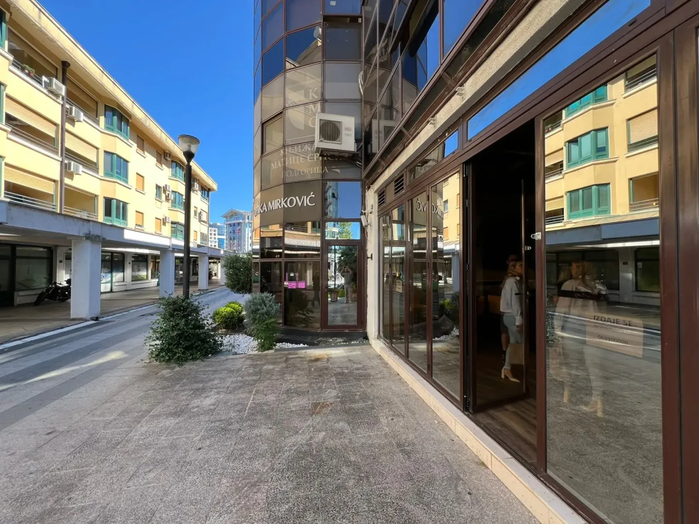 View of the exterior of the commercial space and the building in an urban area.