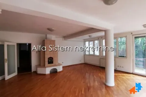 Spacious living room with a fireplace and hardwood flooring. - image 2