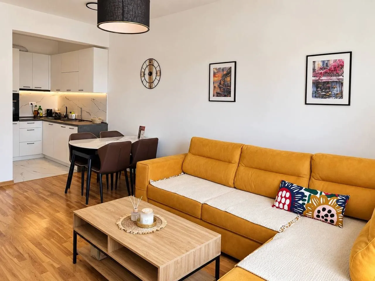 Living room with a sofa and dining area in an open plan layout.