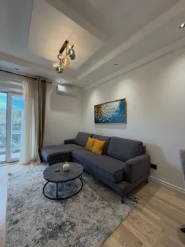 Living room with a sectional sofa, coffee table, and access to the terrace. - image 13