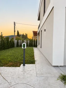 House yard with lawn, walkway, and an electric car charger. - image 3