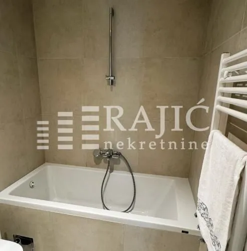 Modern bathroom with a built-in bathtub and shower system.