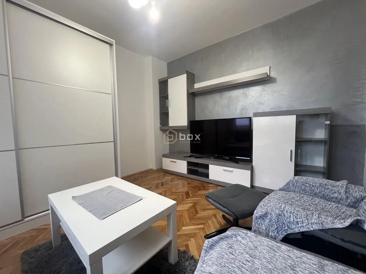 Living room with a sofa set, TV unit, and a large wardrobe.
