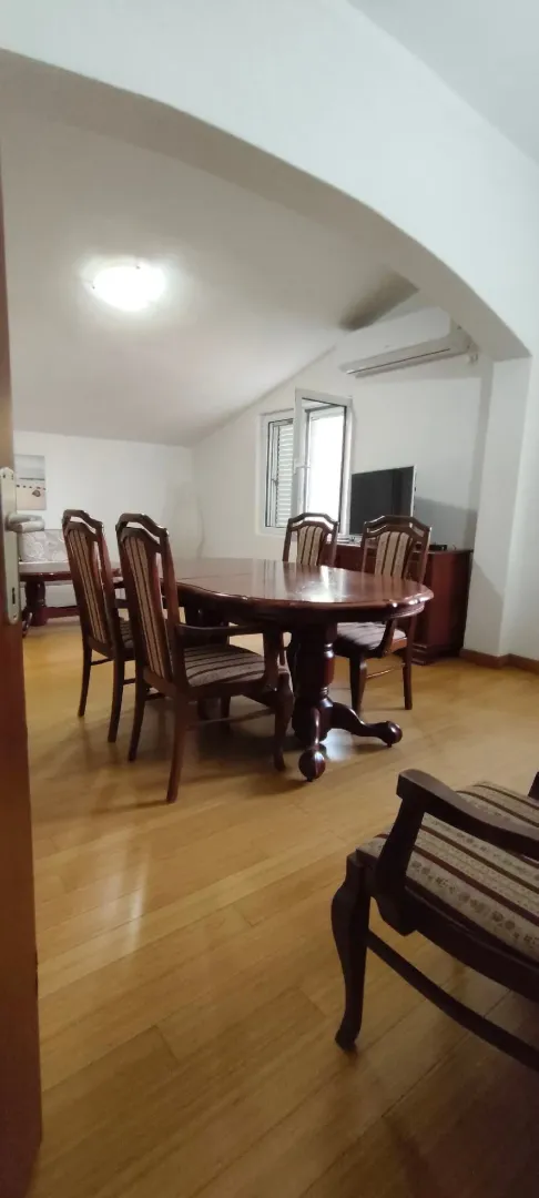 Living room with a dining table and wooden furniture.