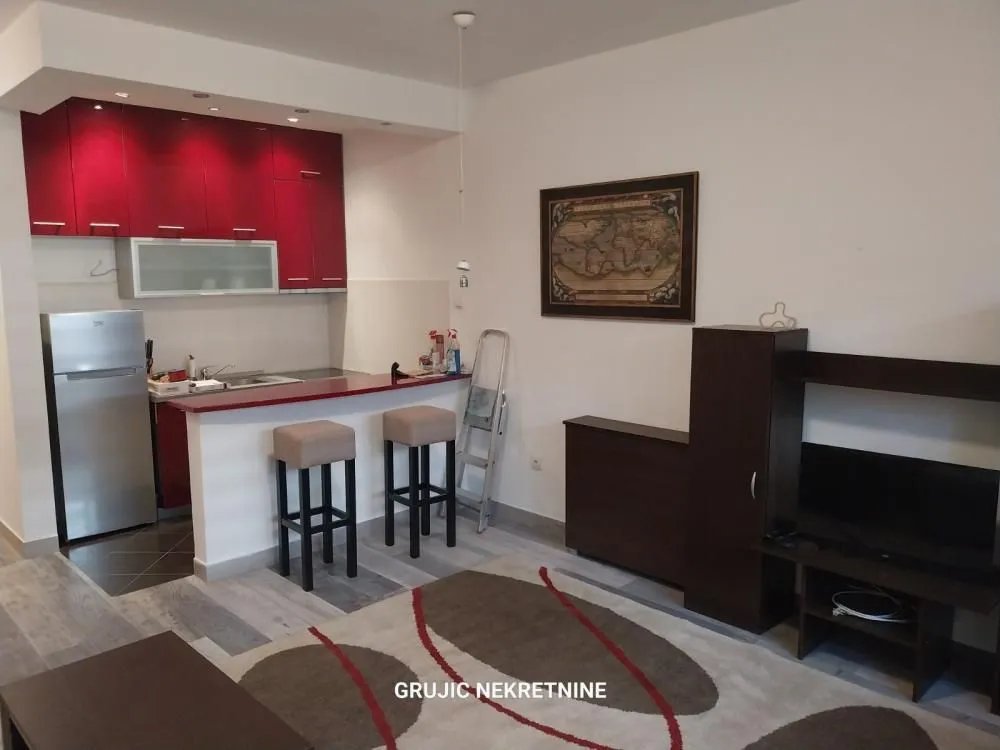 Living room with an open-plan kitchen and a breakfast bar.