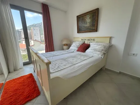 Furnished bedroom with a double bed and a city view. - image 10