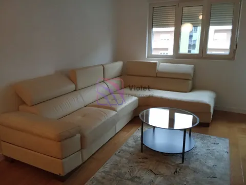 Living room with a sectional sofa and a coffee table. - image 13
