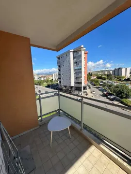 Unfurnished balcony with a view of the street and surrounding buildings. - image 6
