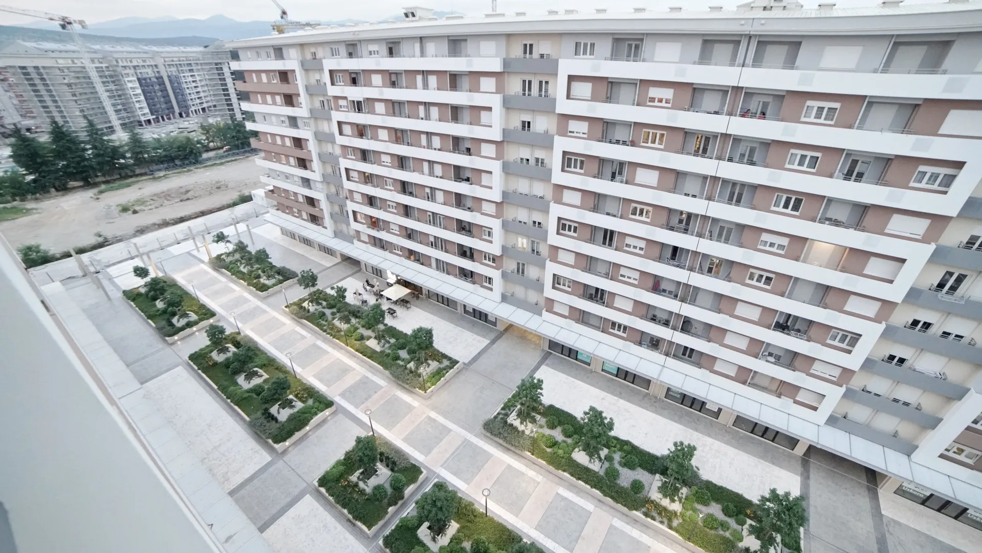 Aerial view of the residential building exterior and landscaped courtyard.