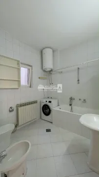 Bathroom equipped with a bathtub, sanitary ware, and a washing machine. - image 19