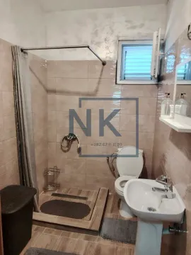 Compact equipped bathroom with a walk-in shower, washbasin, and toilet. - image 8