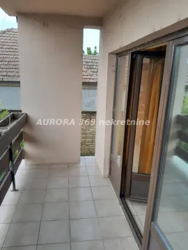Covered balcony with tiled flooring and a view of surrounding buildings. - image 7