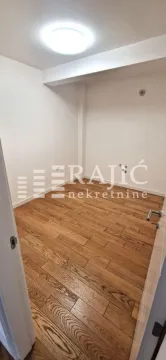 Empty room with wooden flooring and white walls. - image 10