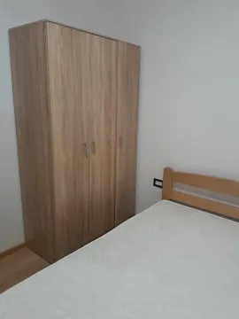 Furnished bedroom with a wardrobe and bed. - image 8
