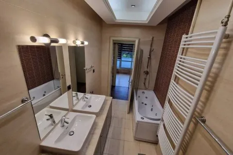 Spacious bathroom with a jacuzzi bathtub, double sinks, and recessed lighting. - image 4