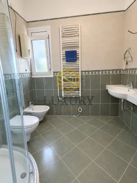 Fully equipped bathroom with a shower cabin, washbasin, and sanitary fixtures. - image 9