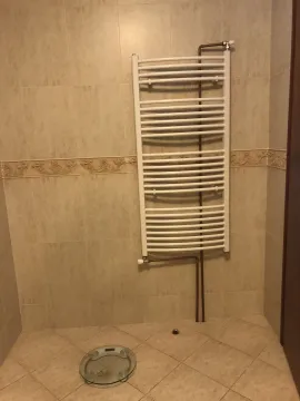 Part of a bathroom with a towel radiator and ceramic tiles. - image 27