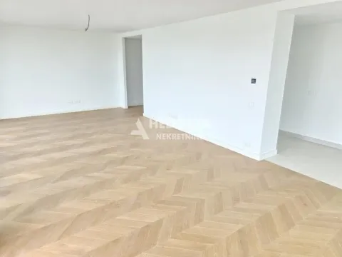 Empty room with herringbone wooden flooring and white walls. - image 10