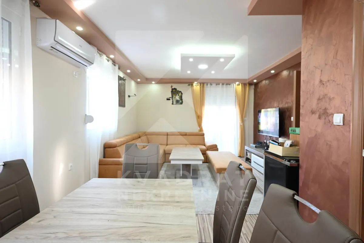 Living room with a sofa set and a dining table.