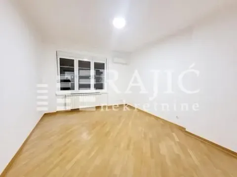 Empty room with wooden flooring and a window. - image 5