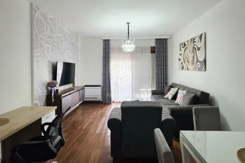 Living room with a sofa, TV, and dining table. - image 20