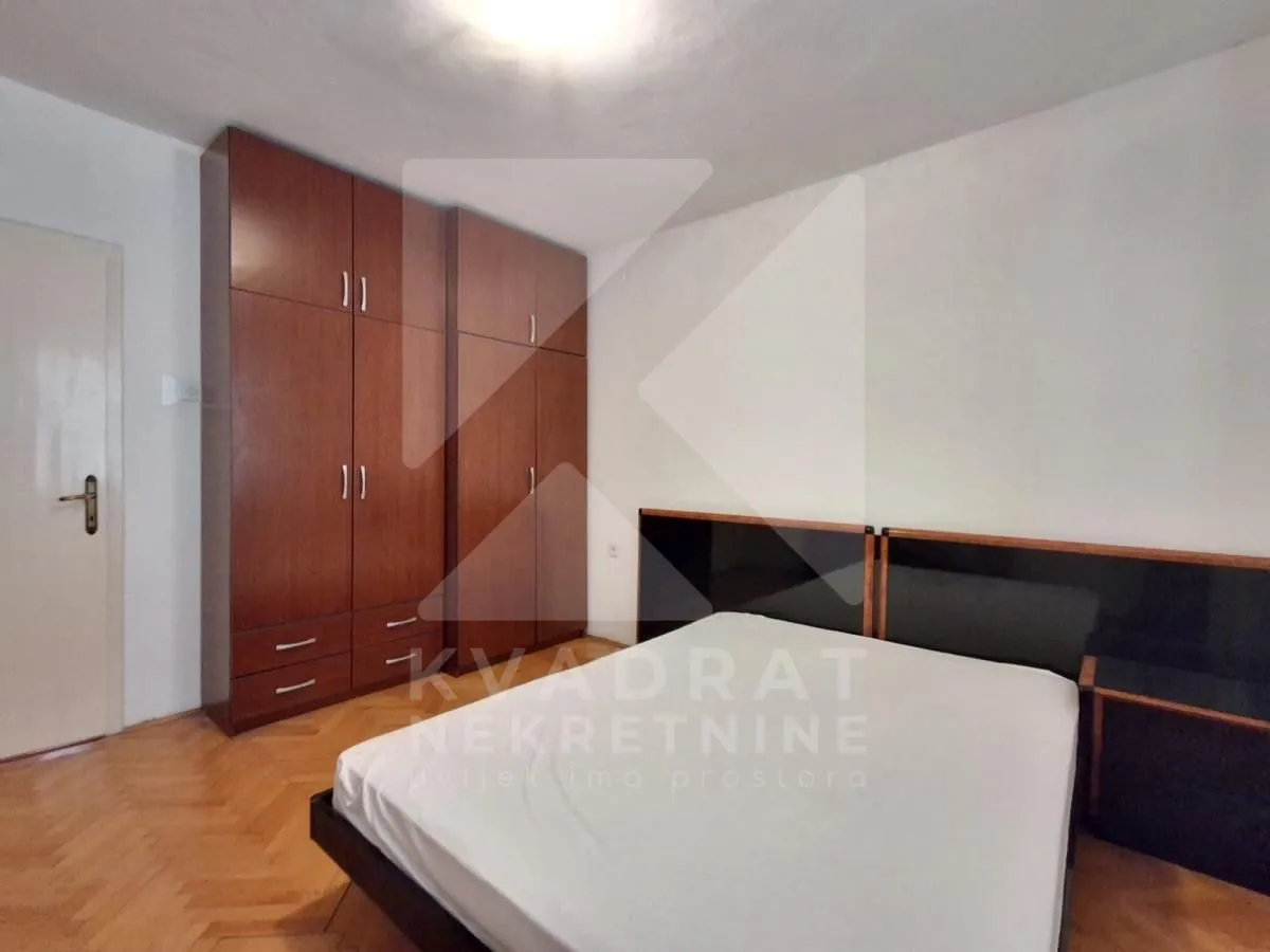 Furnished bedroom with a double bed and a fitted wardrobe.