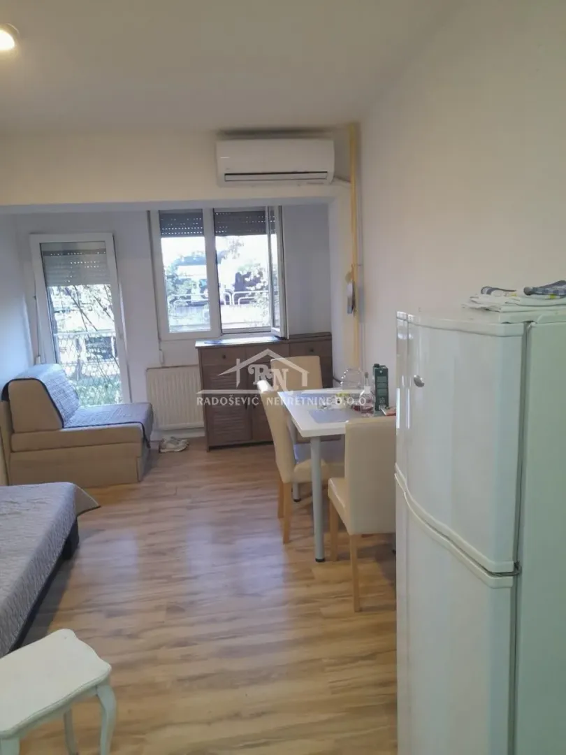 Living room with dining area and terrace access.