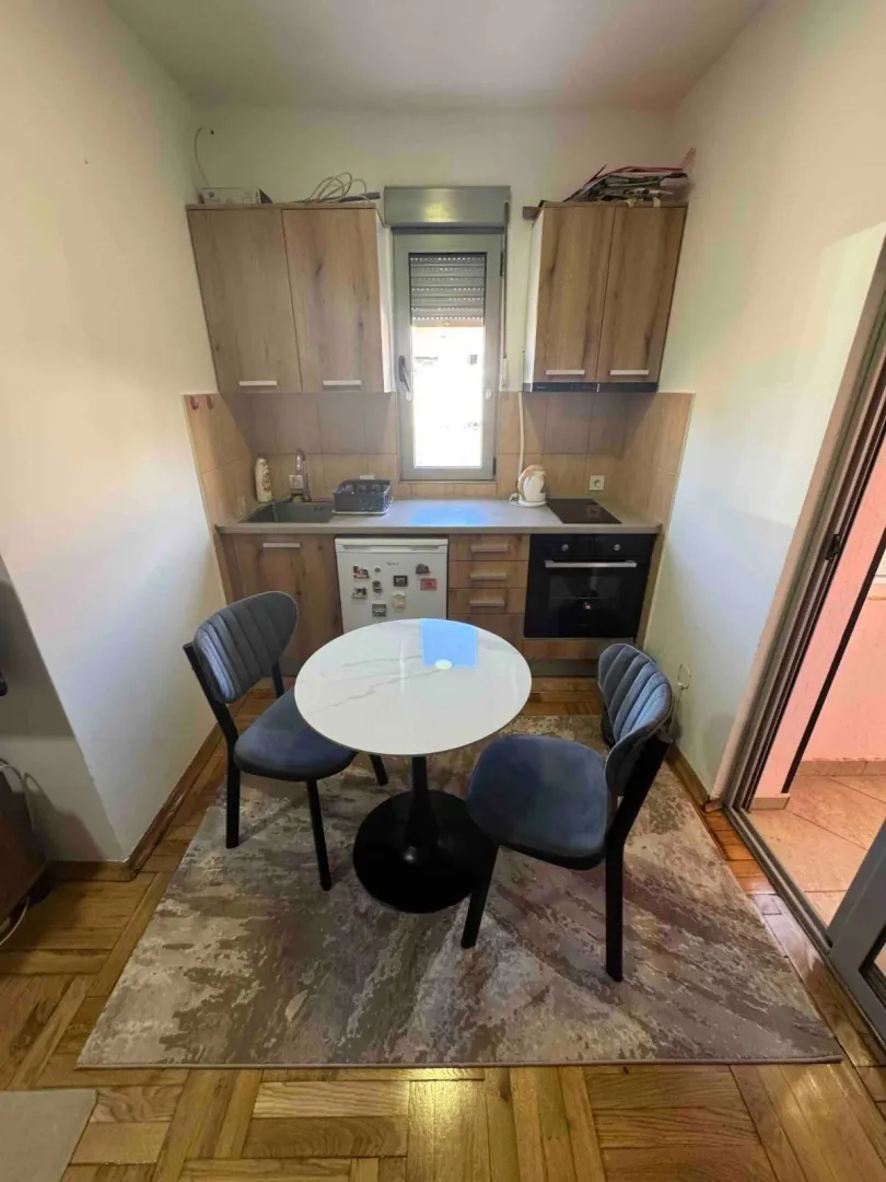 Small kitchen with a dining table and chairs.