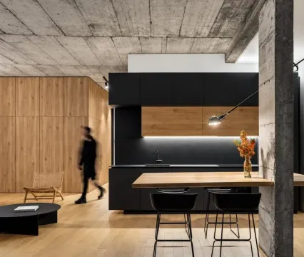 Modern kitchen with dark cabinets and a dining table in an open-plan space. - image 8