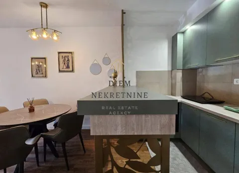 Modern kitchen with dining area and built-in appliances. - image 18