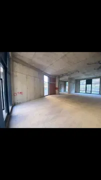 Empty commercial space in grey phase construction with large windows. - image 4