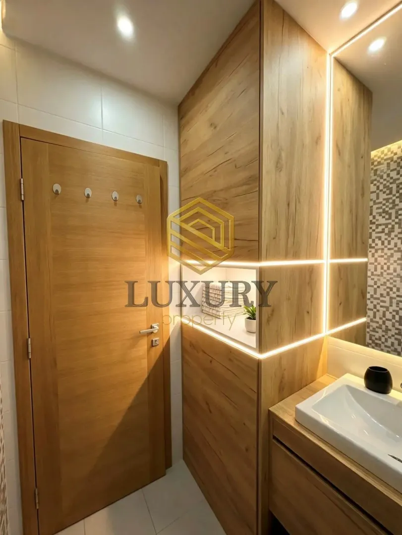 Modern wooden paneling and lighting in the bathroom.